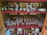 a cabinet with a lot of dishes and glasses on it