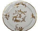 an image of a plate with a gold and white design
