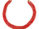 a red beaded necklace on a white background