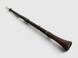 a close up of a bassoon on a white surface with a white background