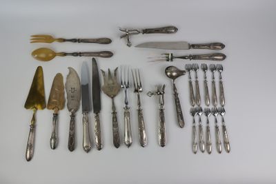a lot of silverware on a table with spoons and knives