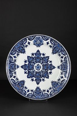 a blue and white plate with a floral design on it