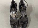 pair of women ' s black shoes on a white surface