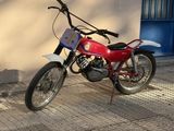 a red motorcycle parked on the side of the street