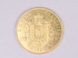 a gold coin with a coat of arms and a crown on it