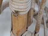 a close up view of a wooden chair with a rope