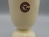 beige and brown ceramic cup with a brown g logo on the bottom
