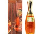 an old bottle of brandy sitting next to a box of wine