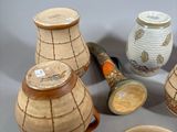 five vases and a bowl sitting on a table