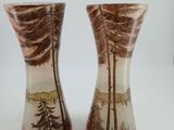 two vases that have been painted with trees on them