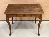 an old wooden table with a drawer on top of it