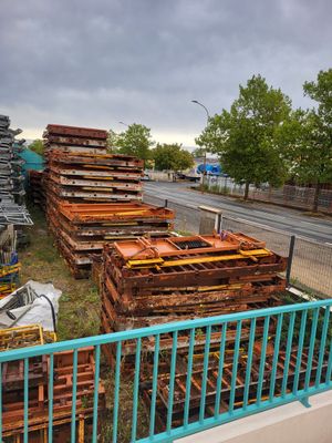 a lot of pallets that are sitting on the side of the road