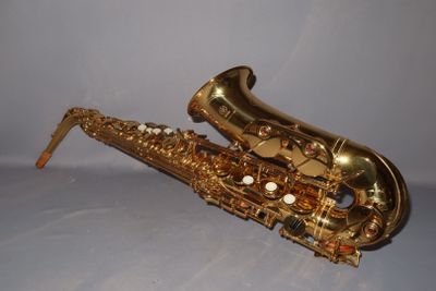 an image of a saxophone sitting on top of a white surface