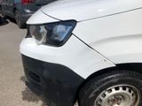 a white van parked in a parking lot with other cars in the background