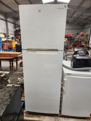 a refrigerator and freezer in a warehouse with other appliances