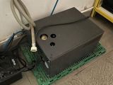 a video game system sitting on the floor next to a remote control
