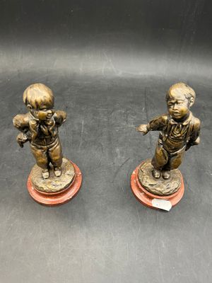 pair of antique bronze figurines of a boy and a girl