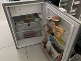 an open refrigerator with a computer on top of it