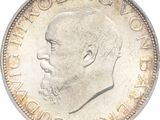 Gros plan sur une pièce de monnaie portant le visage d'un homme