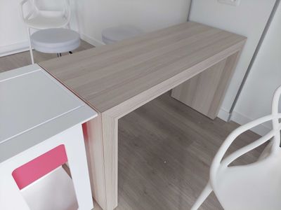 a white chair and a desk in a small room