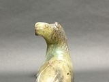 a small statue of a horse that is sitting on a table