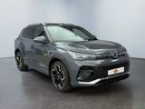 a grey suv is parked in a room with a black floor
