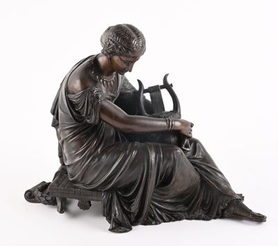bronze statue of a woman sitting on a bench with a vase in her lap
