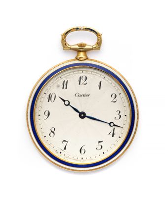 a close up of a pocket watch on a white surface