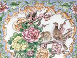 a vase with a bird and flowers painted on it
