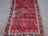 a red and blue rug with a pattern on it