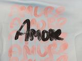 a t - shirt with the word amour written on it