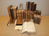 many old books sitting on a table next to each other