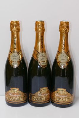 three bottles of champagne sitting next to each other on a table