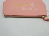 a pink purse with a name on it on a table