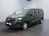 the grey van is parked in a large room with a black floor
