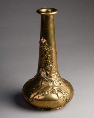 a gold vase that is sitting on a table