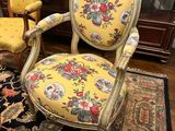 two chairs and a table in a room with a rug on the floor