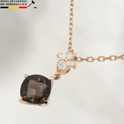 an image of a black and white diamond necklace with a gold chain