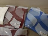 four different colored sheets of paper sitting on the floor
