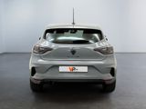 the rear end of a silver car in a white room