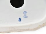 underside view of a porcelain figurine of a man and woman