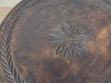 a wooden bowl with a decorative design on it