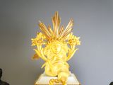 a gold and white cake with flowers on top of it
