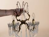 a person holding a crystal chandelier in their hand