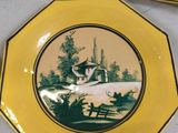 three yellow plates with a picture of a house and trees on them