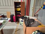 un carton rempli de vêtements et de bagages dans un garage