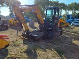 une photo d'un tracteur et d'autres machines dans un champ