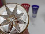 a person holding a glass with a star design on it