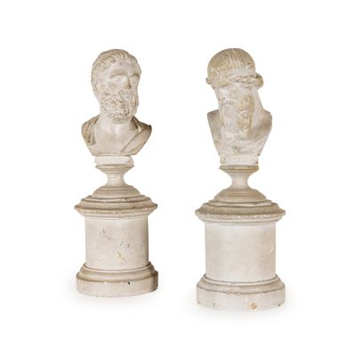 pair of marble busts of men on pedestals on a white background
