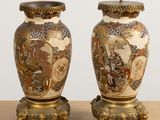 pair of asian vases on stand on table with white background